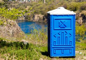 deluxe porta potty near a river